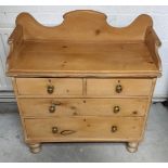 A 19th Century waxed pine wash stand, two short over two long drawers, roll-topped and shaped