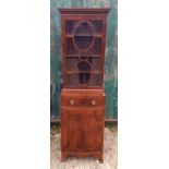 A 19th Century mahogany narrow bow-front cabinet, two sections, glazed upper bookcase section with