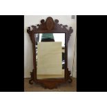 An Edwardian mahogany and chequered strung inlaid fret carved mirror, with oval inlay of Grecian