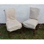 A pair of oak X-framed single chairs with covers (2)