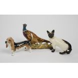 Three Beswick animal studies, including a Siamese cat no 1897, a basset hound no 2045 and a pheasant