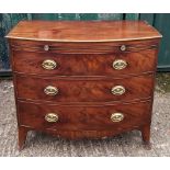 A 19th Century mahogany bow-front chest-of-drawers, three graduated long drawers and brushing slide,