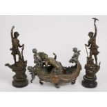 A 19th Century copper centrepiece, boat form, mounted with spelter cherubs, 38 cm long x 29 cm high.