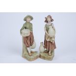 Two Royal Dux Bohemia figures, one of a girl carrying a jug, marked no 984, the other of a boy