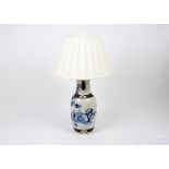 A Chinese porcelain blue and white painted lamp, decorated with applied bronze decoration and