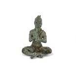 A 20th Century Thai bronze of Phra Aphai Mani crosslegged, playing his magic flute, 15 cm high