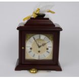 Contemporary German mahogany mantel clock, moulded top with brass carrying handle, 15 cm square