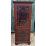 A 20th mahogany corner display cabinet, two astral glazed doors divided by three drawers, shaped