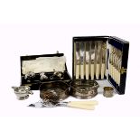 A collection of silver and silver plate, including silver napkin rings, silver sugar tongs, a pair