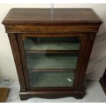 A 19th Century rosewood and inlaid pier cabinet, single glazed door, two fixed shelves, green velvet