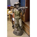 A bronzed garden sculpture of a boy playing a violin, indistinctly signed and marked, 110 cm high