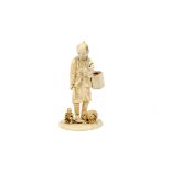 A Meiji period Japanese carved ivory figure of a farmer carrying a basket and scythe, incised