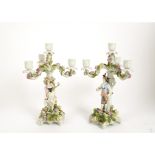 A pair of late 19th Century Bavarian porcelain candlesticks, three branch four lights, floral