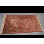 A Turkmen woollen rug, red field, lozenge gulls, geometric border, 184 cm x 102 cm