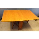 A 1970s teak drop-leaf dining table by A. H. McIntosh and Co, with label, 149 cm wide x 92 cm deep x