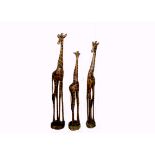 Three large wooden giraffes, carved and painted in naturalistic colours, 135-165 cm high (3)