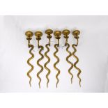 A set of six brass serpentine wall lights, 70 cm high. Together with a brass ceiling light with