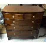 An antique mahogany bow-front chest-of-drawers, two short over three graduated long drawers,