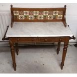 A 19th Century mahogany and marble topped wash stand, mahogany and tiled splash back with finials,