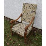 A 19th Century oak framed carved open armchair, floral seat and back