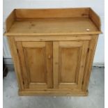 A 19th Century waxed pine two door cupboard, gallery top, 96 cm wide x 45 cm deep x 110 cm high