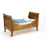 A doll's sleigh bed, with bedding, second half of the 20th Century, 52.5 cm high