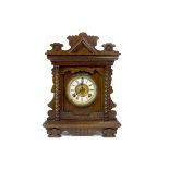 A late 19th Century American oak cased Gingerbread mantle clock by Ansonia Clock Company, New