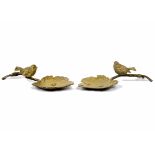 Two gilded metal birds, each perched on a leaf, 23 cm long (2)