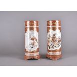 A pair of Kutani Meiji period Japanese porcelain sleeve vases, decorated with dancing females within