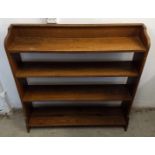 A 20th Century oak open backed bookcase, four shelves, shaped sides, 100 cm wide x 21.5 cm deep x