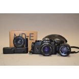 A Nikon EM SLR Camera Outfit, serial no 6974109, shutter working, with three Nikon Series E