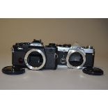 A Pair of Olympus OM SLR Bodies a Olympus OM-2n body, serial no 940790, motor drive cover missing,