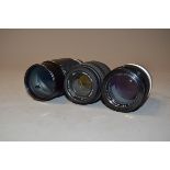 Two Nikon and a Sigma Lenses, a Nikkor-Q Auto 135mm f/2.8 in a bubble case, a Nikon Series E 70-