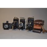 A Group of Folding Roll Film Cameras, Zeiss Ikon Ikonta (2 examples), Ensign Selfix, Six-20 Kodak