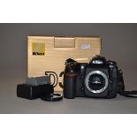 A Nikon D300 DSLR body, serial no 8015266, shutter working, with charger, 2 batteries, instructions,