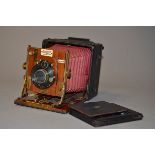 A Sanderson Regular Model Hand and Stand Folding Plate Camera, red bellows, 3¼ x 4¼," serial no