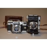 Two German Folding 35mm Rangefinder Cameras, a Voigtländer Vitessa camera, with an Ultron 50mm f/2