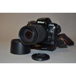 A Nikon F90X SLR Camera, serial no 2003687, condition F, sickiness at back near battery grip MB-