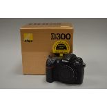 A Nikon D300 DSLR body, serial no 8034834, shutter working, with charger, battery, instructions,