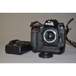 A Nikon D2H DSLR Camera Body, and Charger serial no 2033909, condition G, powers up, shutter