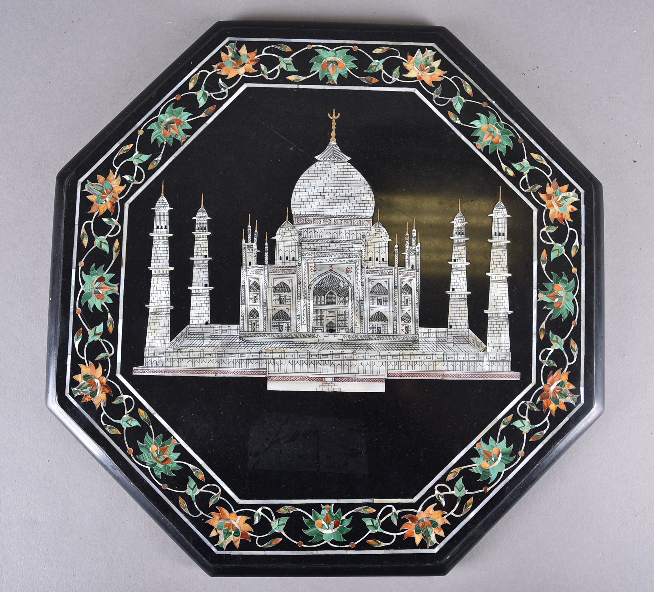 An octagonal pietra dura inlaid panel centred with a mother of pearl Indian temple, possibly the Taj