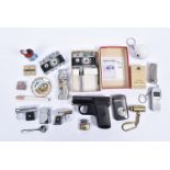 A collection of novelty lighters, in the form of guns, toothbrushes, golf balls, cigarettes and more