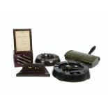 A large collection of bakelite desk equipment, including pen trays, calendars, stamps and