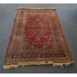 A Middle-Eastern rug, cobalt pole medallion and floral decoration on red ground, cobalt spandrels,