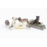 A collection of ceramic figures, including elephant, hippopotamus, rhinoceros, and dogs, together