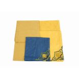 A set of six Jesvrvm table cloths, in red, yellow, blue and green cotton with lace decoration,