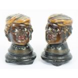 A pair of 1920s American ceramic money boxes in the form of Afro-American female heads, 16 cm high (