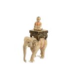 A carved Indian elephant, mounted with a Buddha, 68 cm high