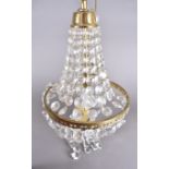 A cut glass basket chandelier with gilt metal support and surround