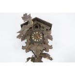 A 20th Century Black Forest cuckoo clock, vine leaf decoration, Roman numerals (af)